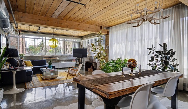 Sun-drenched, chef's kitchen, and beautifully collected, Arts District loft